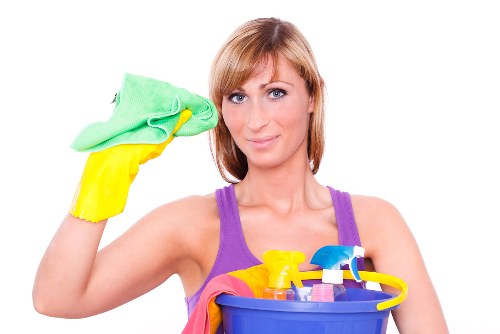 Professional home cleaners working in a London apartment living room