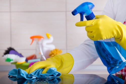 Technician cleaning carpets in a London flat with limited access