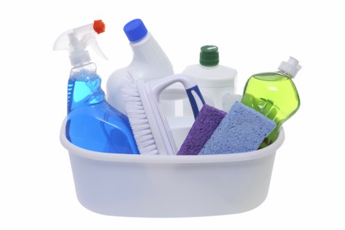 Cleaning staff tidying a shared office kitchen in London