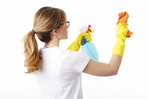 Local oven cleaner working in a London kitchen with tight access