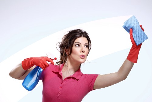 A local technician cleaning glass at a London office building